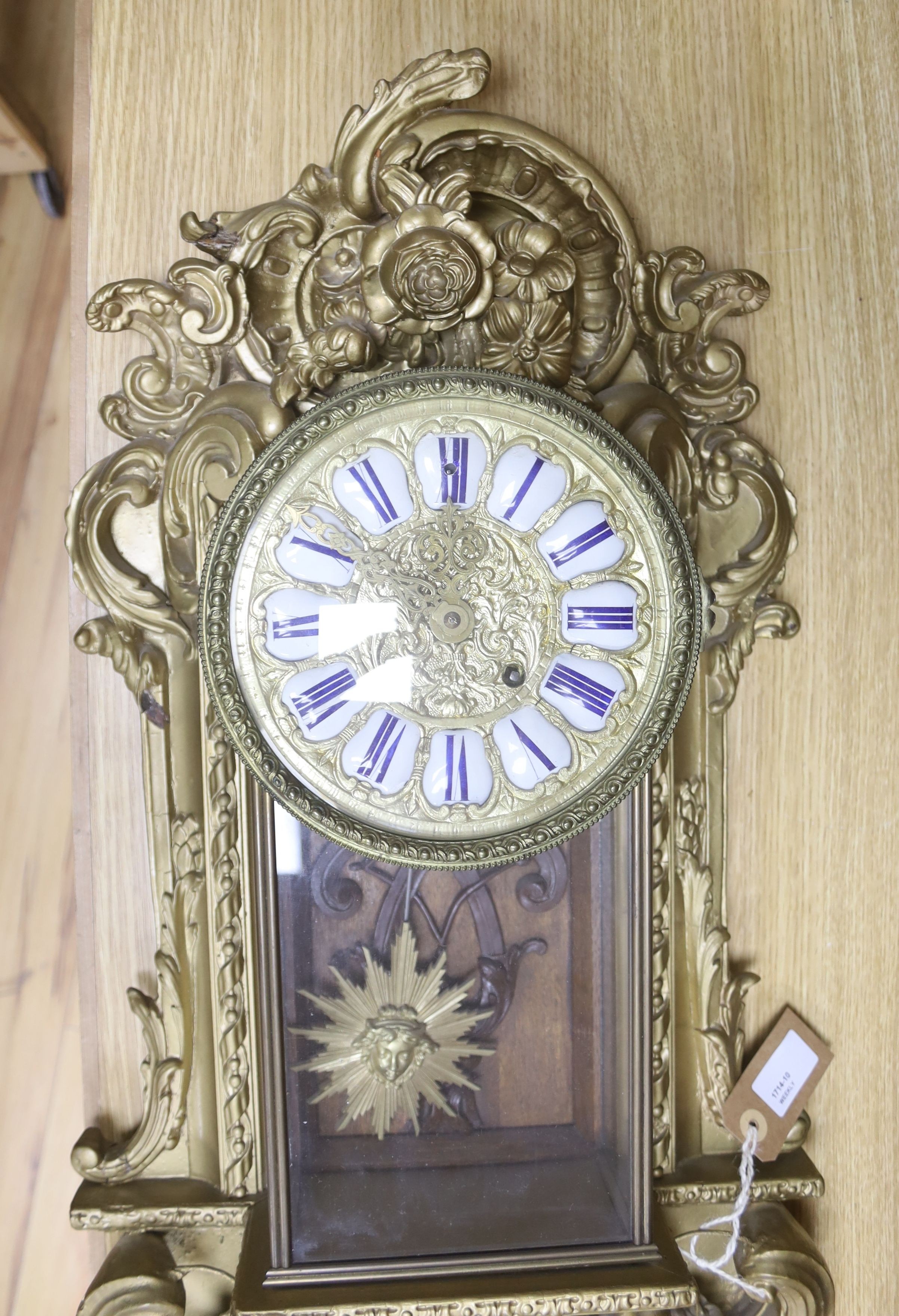 A 19th century French gilt and composition wall clock, with scrolled acanthus carving and 'sunburst' pendulum, 72cm high